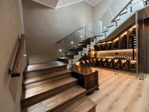 View up the timber staircase at House 671 beside the illuminated wine display